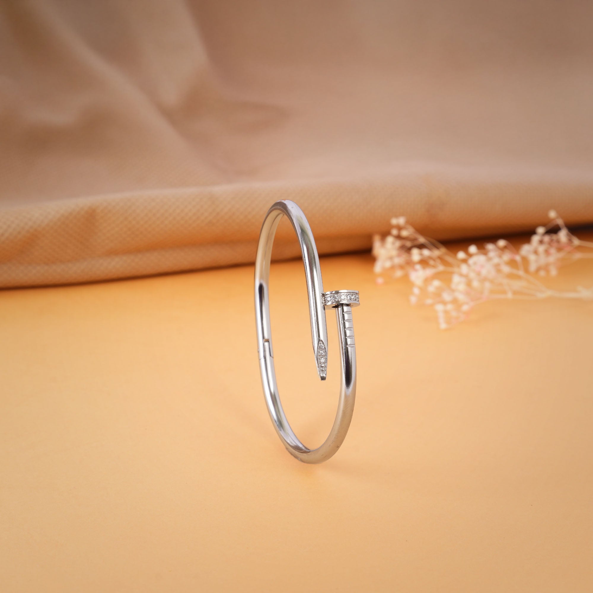 Silver bracelet stacked with watches and chains