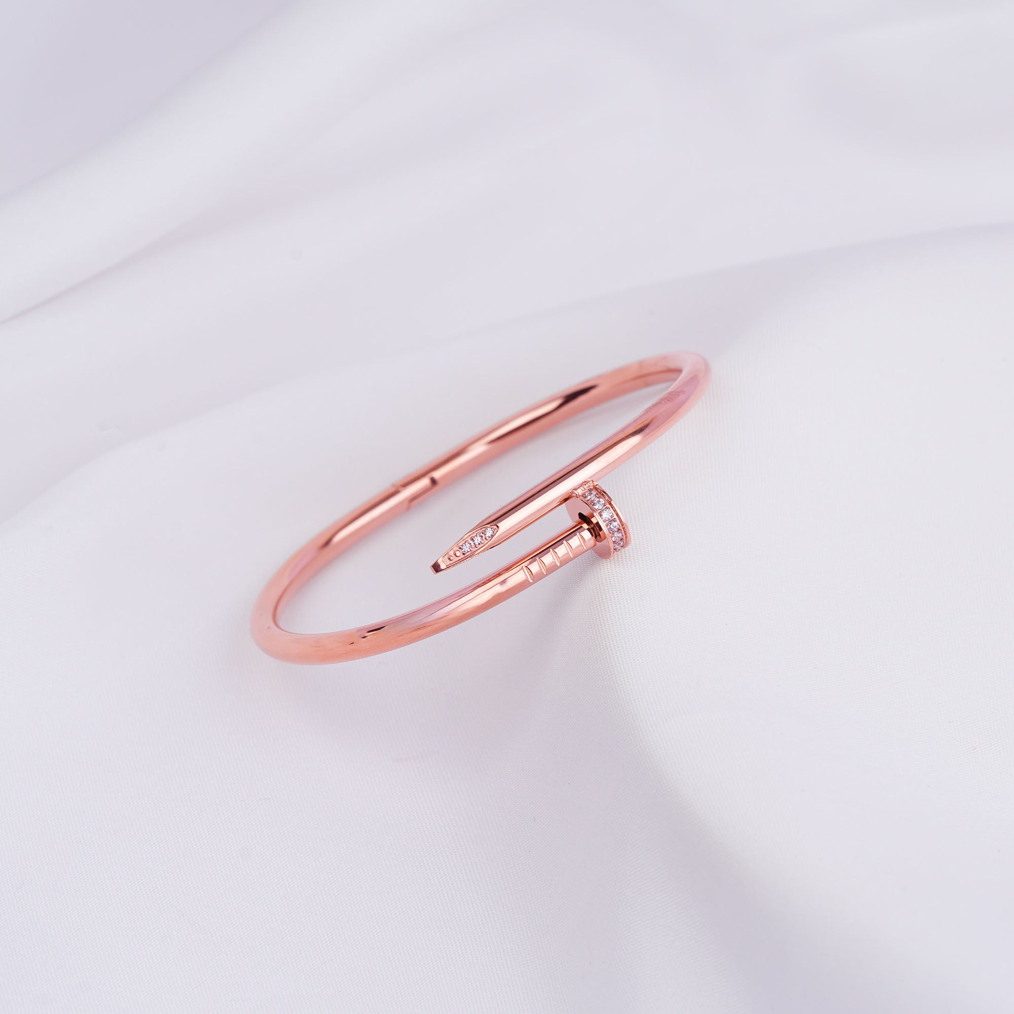 Nail bangle bracelet paired with pearl accessories