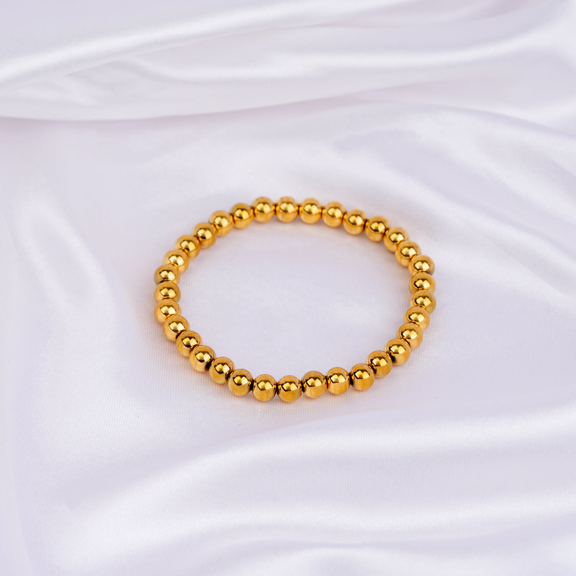 Slip-on bracelet with polished gold beads