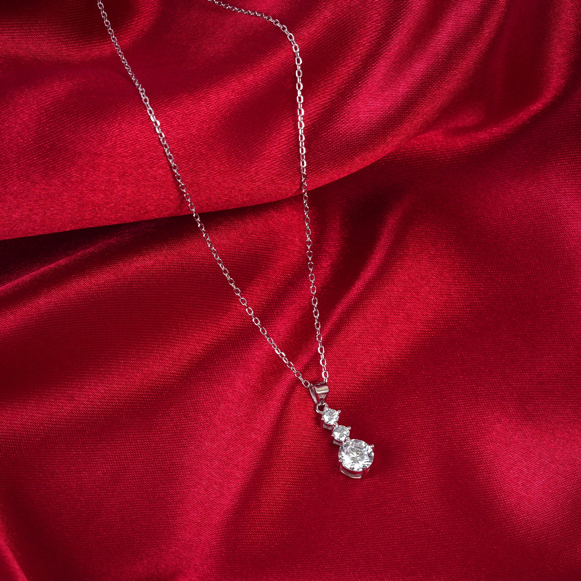 Diamond necklace on a red satin background