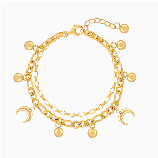Gold bracelet with various charms on a white background