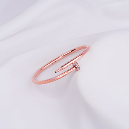 Nail bangle bracelet paired with pearl accessories