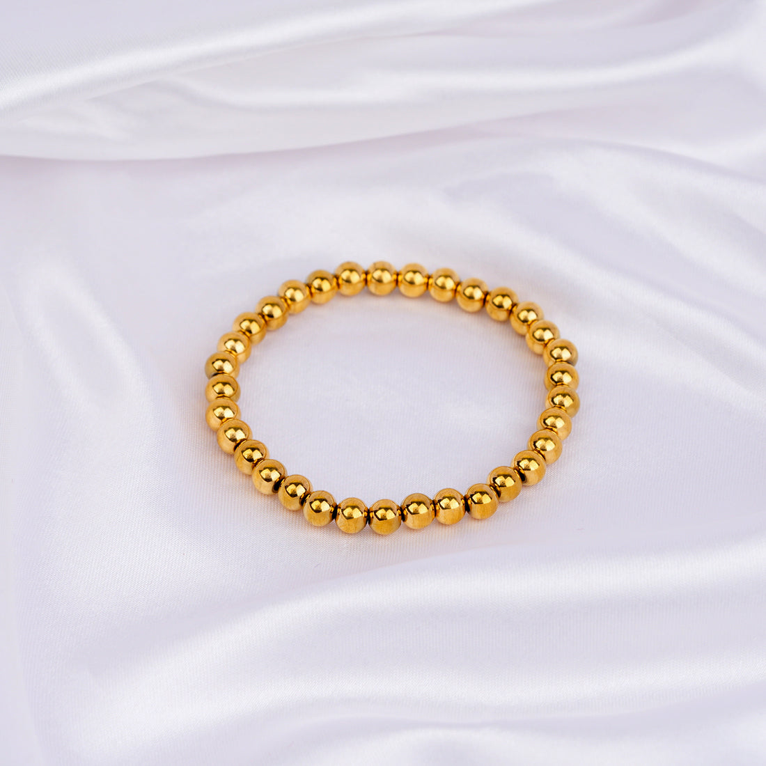 Slip-on bracelet with polished gold beads