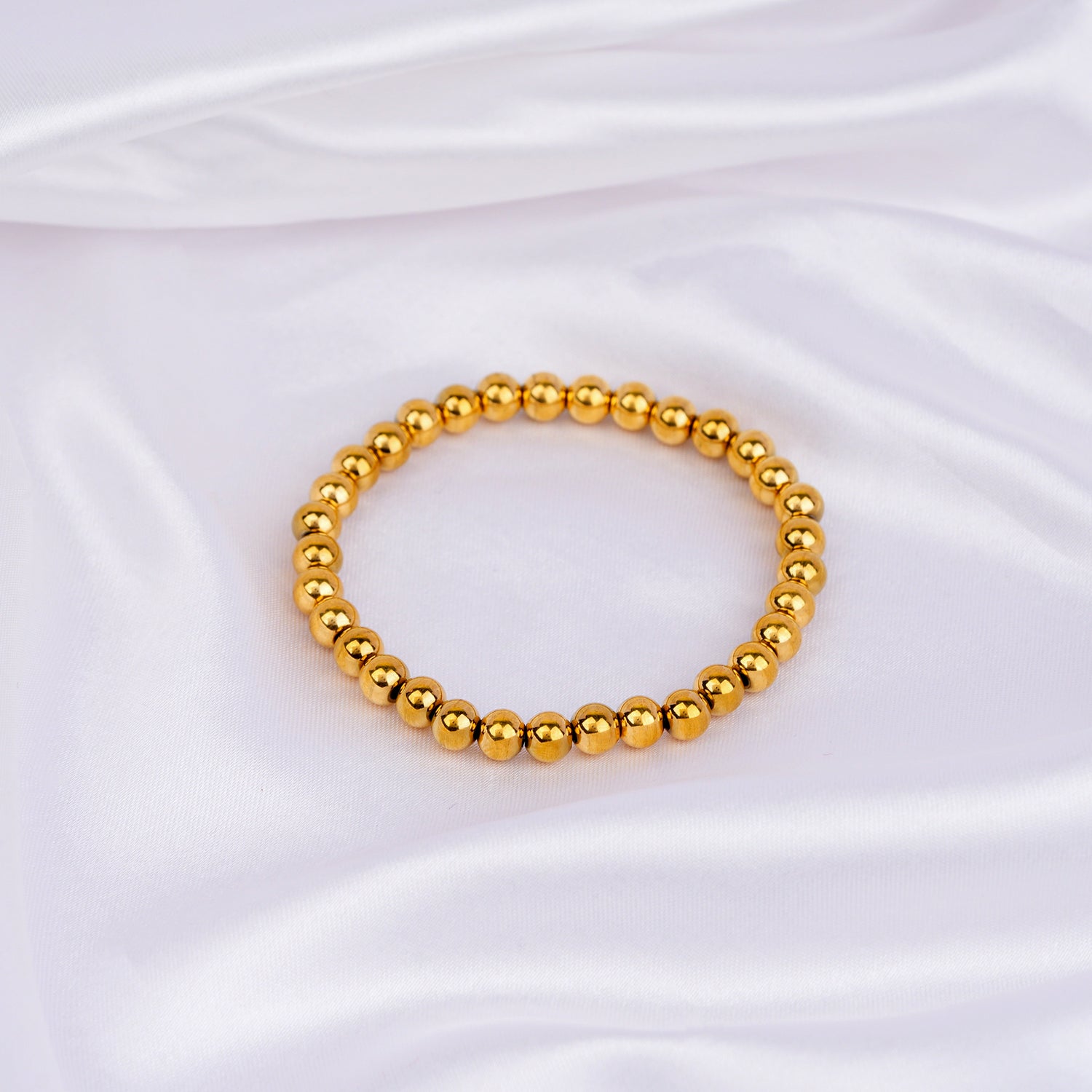 Slip-on bracelet with polished gold beads