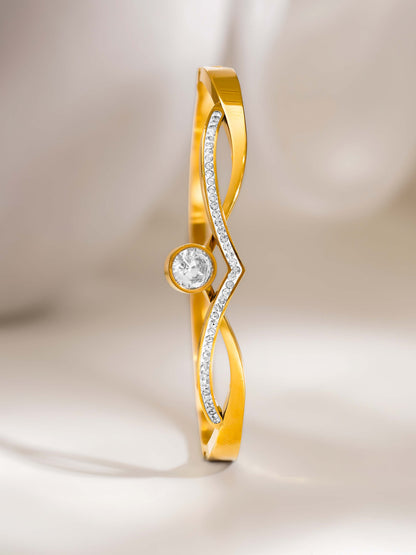 Gold ring with a diamond on a soft beige background