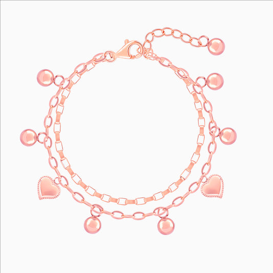 Stack of pink gold bracelets with heart and round charm on a white background