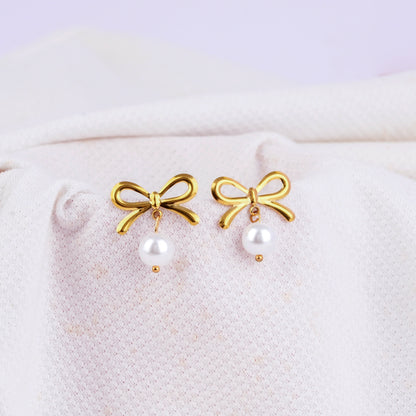 Gold hoop earrings with bow and white pearl