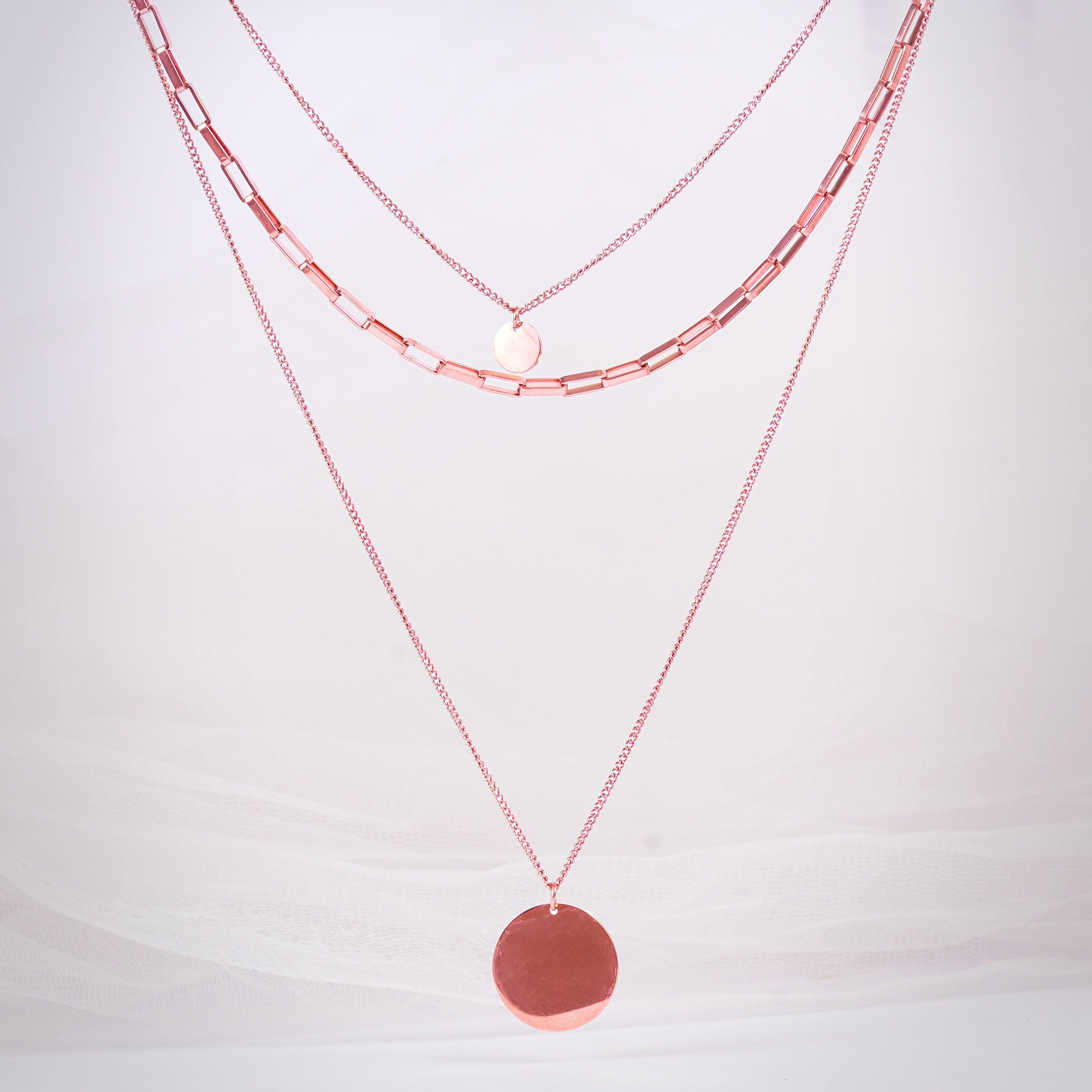 Triple strand rose gold necklace with medallions