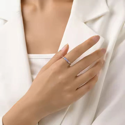Hand wearing a ring with a white background