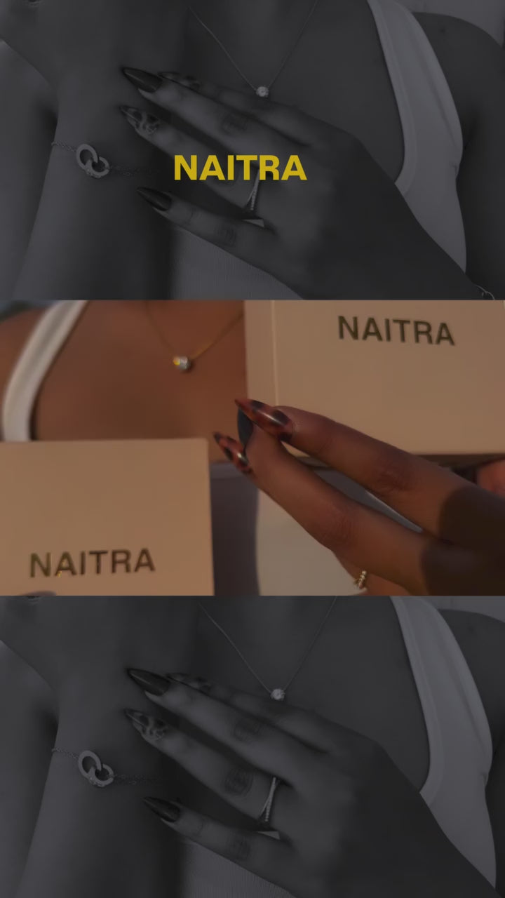 NAITRA styling reel of an 18K gold plated solitaire statement necklace worn with zirconia hoop earrings and a multistrand gold bracelet